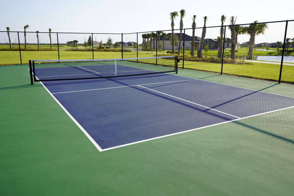 Close up of a pickleball court in a tropical setting.