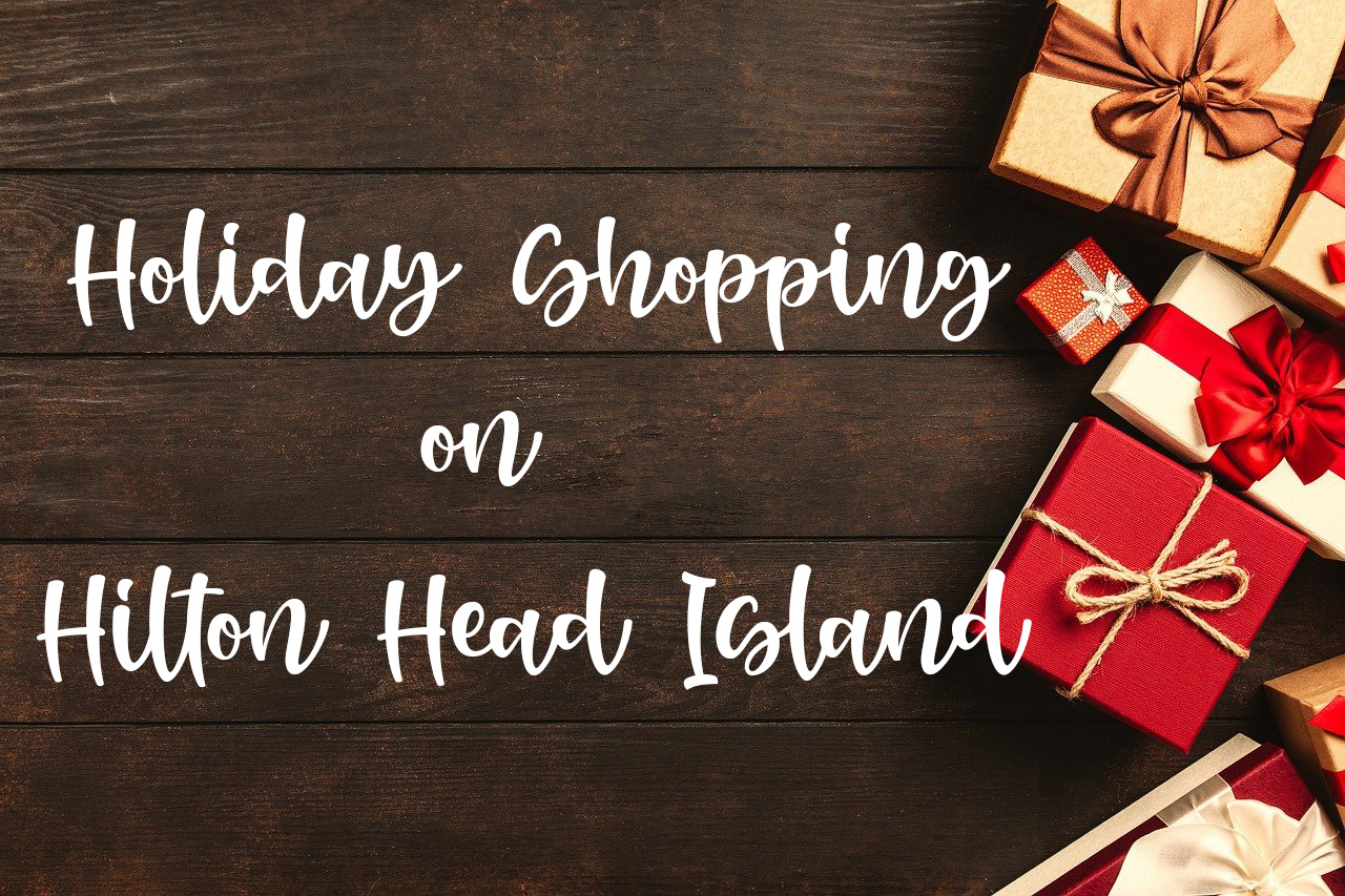 Brown background with gifts on the right hand side with red and gold bows, holiday shopping on hilton head island in white lettering