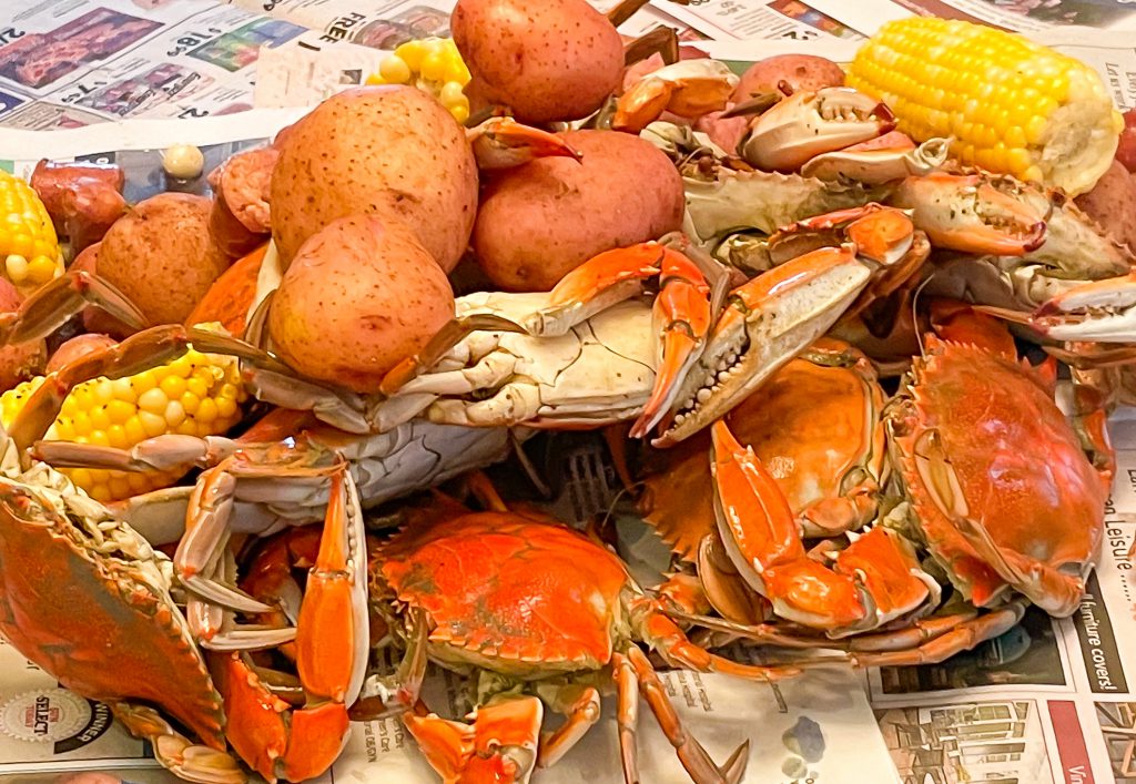 Crab, potatoes, corn served on newspaper