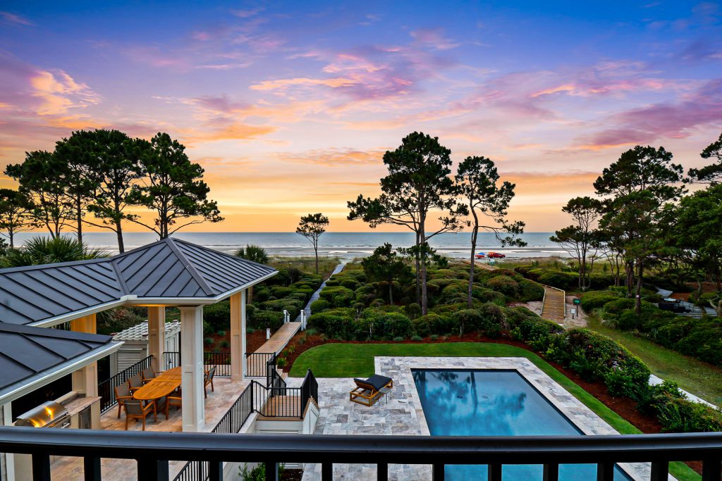 picture of backyard of 22 Sandhill Crane Road with a pool, and access to the beach in the background